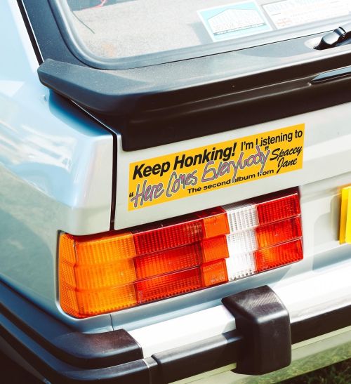 Keep Honking yellow bumper sticker by Spacey Jane